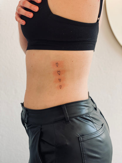 tiny hearts tattoo